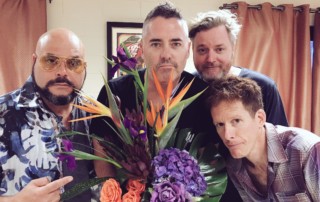 The Barenaked Ladies pose with a bouquet of flowers and offer an apology for offending Hoobastank.
