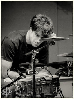 Lower Dens' Nate Nelson leans over his drum kit during An Evening With Lower Dens at WTMD (photo by Steve Parke)