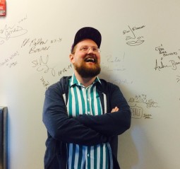 Baltimore electronic musician Dan Deacon poses by his signature on the WTMD wall. (photo by Sam Sessa)